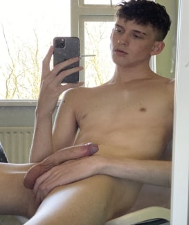 Nude boy taking a selfie